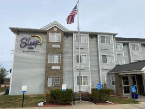 a large building with a flag on top of it at Sleep Inn St. Robert-Fort Leonard Wood in Saint Robert