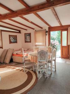 a bedroom with a table and chairs and a bed at Apartment Beganovic-Centar in Kulen Vakuf