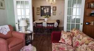 a living room with a couch and a table with chairs at Blue Spruce Bed and Breakfast in Gravenhurst