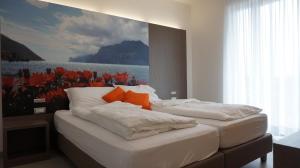 A bed or beds in a room at Residence Rivachiara (check-in at Hotel Riviera in Viale Rovereto, 95)