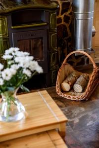 a basket of bread and a vase of flowers on a table at Belianska Chata in Ždiar