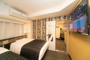 Cama ou camas em um quarto em APA Hotel Kyoto Ekimae
