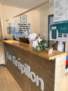 a store counter with flowers on top of it at Village Vacances Le Grépillon in Les Rousses