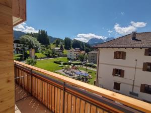 a balcony with a view of a courtyard and mountains at Hotel Da Marco in Vigo di Cadore