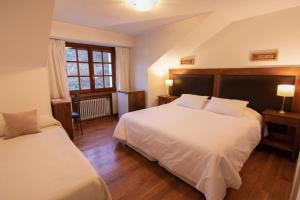 Postel nebo postele na pokoji v ubytování Hosteria Hostal del Esquiador