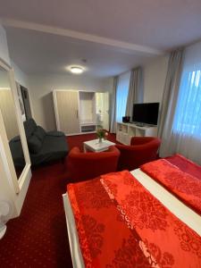 a hotel room with two beds and a living room at Hotel Pension Haus Talblick Edersee in Hemfurth-Edersee