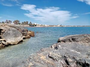 a body of water with rocks in the water at Appartamento Mariella in Pachino