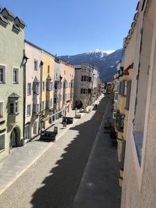 an empty street in a city with buildings at Ida - historic town apartments in Vipiteno