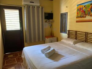 um quarto com uma cama com duas toalhas em Pousada Numei de Jeri em Jericoacoara