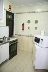 a kitchen with a stove and a microwave at Royal Maadi Hotel in Cairo