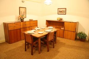 a dining room with a wooden table and cabinets at Royal Maadi Hotel in Cairo