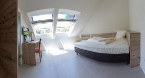 a bedroom with a bed and a window at Landhotel Weihermühle in Thaleischweiler-Fröschen