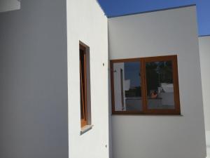 a white building with a window on the side of it at Sossego Salgado in Tavira