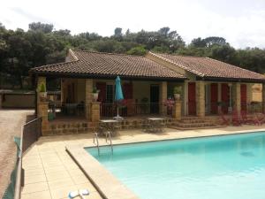 a house with a swimming pool in front of it at La Combe Joseph in Remoulins