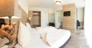 a bedroom with two white beds and a tv at Landhotel Weihermühle in Thaleischweiler-Fröschen