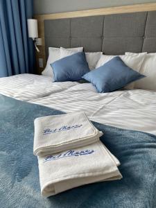 two towels are sitting on a bed at Apartament 425 - Bel Mare Międzyzdroje in Międzyzdroje