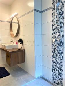 a bathroom with a sink and a mirror at Apartments Am See in Klopein am Klopeiner See