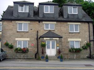 a brick house with a white door and windows at Thurlestone House in St Ives