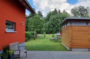 a bench next to a house with a yard at Finger's Hyggelig-Haus in Erbach