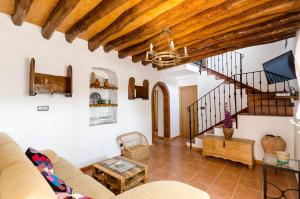 a living room with a couch and a staircase at Cortijo Cabrilla in Periana