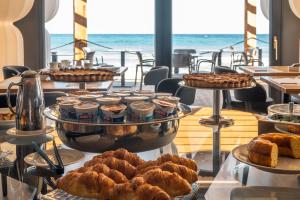 a buffet with various pastries and desserts on display at Hotel Punta Tipa in Trapani