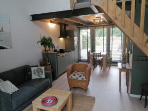 a living room with a couch and a table at Park aan Zee in Vlissingen