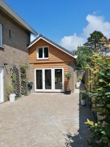 a house with a large driveway in front of it at Park aan Zee in Vlissingen