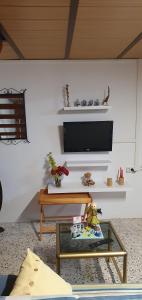 a living room with a tv and a table at Casa Rural EL PUENTE in Taganana