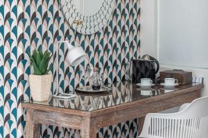 a dining room table with a patterned wall at Ballinderry, The Robertson Guest House in Robertson