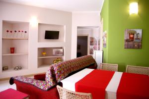 a living room with a red and white table and chairs at Residence Giglio Comer See in Gravedona