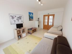 a living room with two beds and a television at Dream on Peniche - Apartment in Peniche