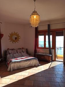 a bedroom with a bed and a chandelier at Casa Vacanze Monte Argentario in Porto Santo Stefano