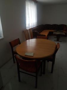 a living room with a wooden table and chairs at Apartman Nadija in Jajce