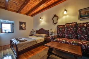 a living room with a bed and a couch at Royal Villa Ana in Cetinje