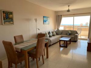 a living room with a couch and a table at King's Palace - very spacious 1 bed apartment in Paphos