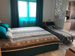 Posteľ alebo postele v izbe v ubytovaní Studio Turquoise - Eforie Nord