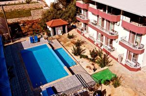 an overhead view of a swimming pool next to a building at Rose Hotel B&B in Patara