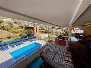 a view of a swimming pool from the balcony of a house at Rose Hotel B&B in Patara