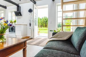 a living room with a couch and a table at Ferielejlighed Holmevej in Næstved