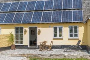 a house with solar panels on the side of it at Ferielejlighed Holmevej in Næstved