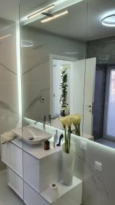 a bathroom with a sink and a large mirror at Casa Aurelia Bed & Breakfast in Krk