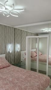 a bedroom with two beds and a mirror at Casa Aurelia Bed & Breakfast in Krk