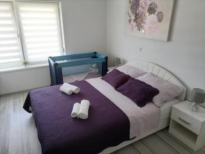 Postel nebo postele na pokoji v ubytování Apartman Lidija
