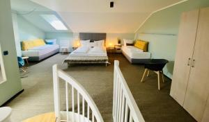 a bedroom with a bed and a living room with a couch at Designhotel Whitman in Ascheberg