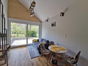 a living room with a blue couch and a table at Apartament Bukowy Las in Zachełmie