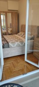 a room with two beds and a mirror at Apartman Mateja in Trebinje