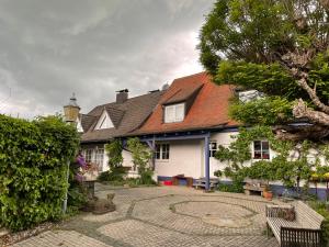 a white house with a patio in front of it at Gaensebluemchen 2 Apartment daisy 2 in Walsdorf