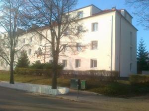a large white building on the side of a street at Gdynia99 in Gdynia
