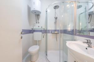 a bathroom with a shower and a toilet and a sink at Villa Markoc in Cavtat