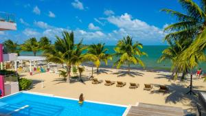 a view of the beach from the balcony of a resort at The Ellysian Boutique Hotel in Placencia Village